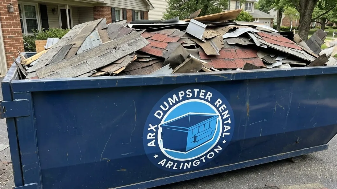 Hail and storm damage cleanup in Arlington, Texas — container taking shingle debris and snapped limb wood